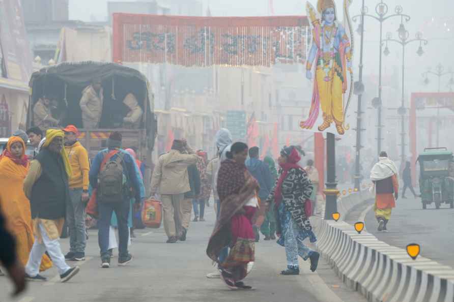 Ayodhya: Hindu devotees on a road during a cold and foggy winter...